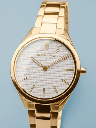 Angle shot of Bering Ultra Slim 17231-734 White Dial Gold Stainless Steel Womens Watch on white background