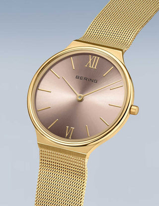 Angle shot of Bering 18434-336 Pink Dial Gold Stainless Steel Womens Watch on white background