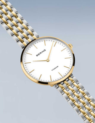 Angle shot of Bering 19334-010 White Dial Gold Titanium Womens Watch on white background