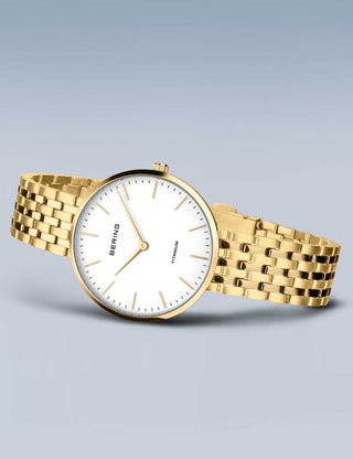 Angle shot of Bering 19334-334 White Dial Gold Titanium Womens Watch on white background