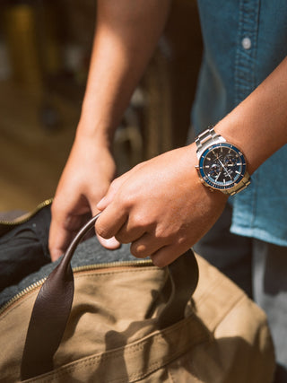 Angle shot of Bulova Chronograph 98B301 Blue Dial Rose Gold Stainless Steel Unisex Watch on white background