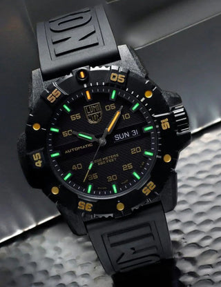 Angle shot of Luminox XS.3865.GOLD Black Silicone Unisex Watch on white background